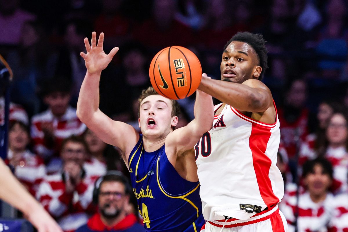 Dec 29, 2025; Tucson, Arizona, USA; South Dakota State Jackrabbits center Damon Wilkinson (34) and Arizona Wildcats forward Tobe Awaka (30) attempt to catch the ball during the second half of the game at McKale Memorial Center. Mandatory Credit: Aryanna Frank-Imagn Images