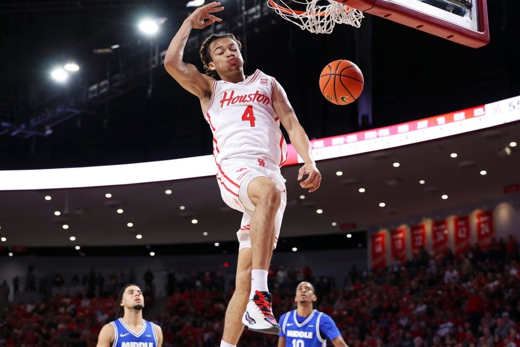 Dec 29, 2025; Houston, Texas, USA; Houston Cougars guard Kingston Flemings (4) dunks the ball during the second half against the Middle Tennessee Blue Raiders at Fertitta Center. Mandatory Credit: Troy Taormina-Imagn Images