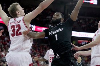 UW-Milwaukee guard Amar Augillard (1) scores on Wisconsin forward Aleksas Bieliauskas (32) during the first half of their game Tuesday, December 30, 2025 at the Kohl Center in Madison, Wisconsin.