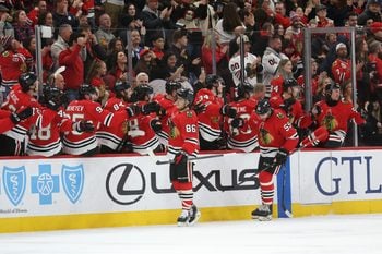 Dec 30, 2025; Chicago, Illinois, USA; Chicago Blackhawks center Teuvo Teravainen (86) high-fives teammates after scoring during the second period against the New York Islanders at United Center. Mandatory Credit: Talia Sprague-Imagn Images