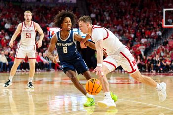 Dec 30, 2025; Lincoln, Nebraska, USA; Nebraska Cornhuskers guard Cale Jacobsen (31) drives agaisnt New Hampshire Wildcats guard Kijan Robinson (8) during the first half at Pinnacle Bank Arena. Mandatory Credit: Dylan Widger-Imagn Images