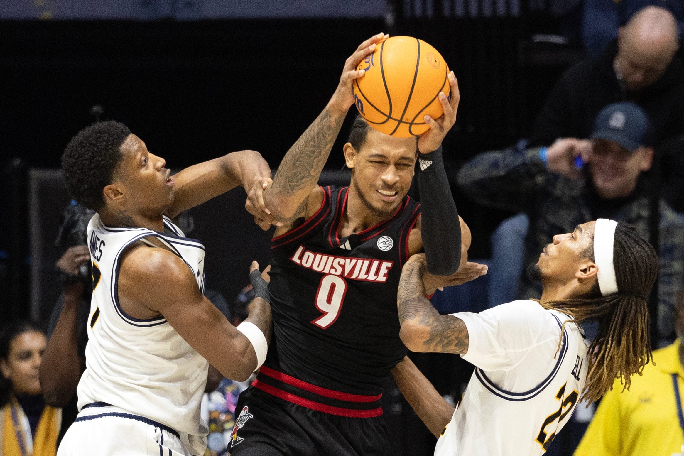 Dec 30, 2025; Berkeley, California, USA; Louisville Cardinals forward Khani Rooths (9) is double-teamed by California Golden Bears defenders Dai Dai Ames (7) and Chris Bell (22) during the second half at Haas Pavilion. Mandatory Credit: D. Ross Cameron-Imagn Images