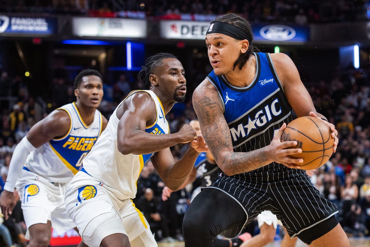 Dec 31, 2025; Indianapolis, Indiana, USA;  Orlando Magic forward Paolo Banchero (5) dribbles the ball while Indiana Pacers guard/forward Aaron Nesmith (23) defends in the second half at Gainbridge Fieldhouse. Mandatory Credit: Trevor Ruszkowski-Imagn Images