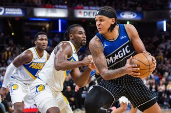 Dec 31, 2025; Indianapolis, Indiana, USA;  Orlando Magic forward Paolo Banchero (5) dribbles the ball while Indiana Pacers guard/forward Aaron Nesmith (23) defends in the second half at Gainbridge Fieldhouse. Mandatory Credit: Trevor Ruszkowski-Imagn Images
