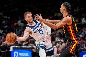 Dec 31, 2025; Atlanta, Georgia, USA; Minnesota Timberwolves guard Donte Divincenzo (0) passes the ball against Atlanta Hawks forward Zaccharie Risacher (10) during the second half at State Farm Arena. Mandatory Credit: Dale Zanine-Imagn Images