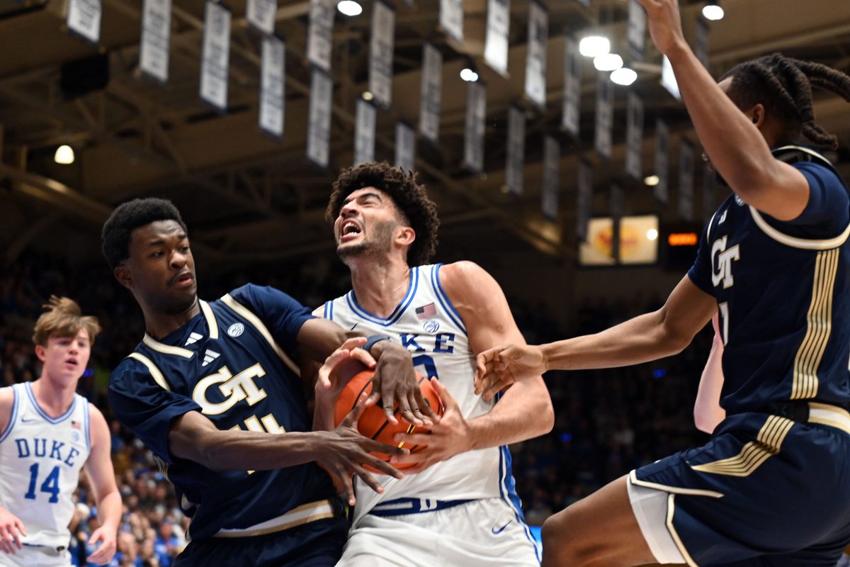 Dec 31, 2025; Durham, North Carolina, USA; Georgia Tech Yellow Jackets forward Kowacie Reeves Jr. (14) attempts to steal the ball from Duke Blue Devils forward Cameron Boozer (12) as he drives to the basket during the second half at Cameron Indoor Stadium. The Blue Devils won 85-79. Mandatory Credit: Rob Kinnan-Imagn Images