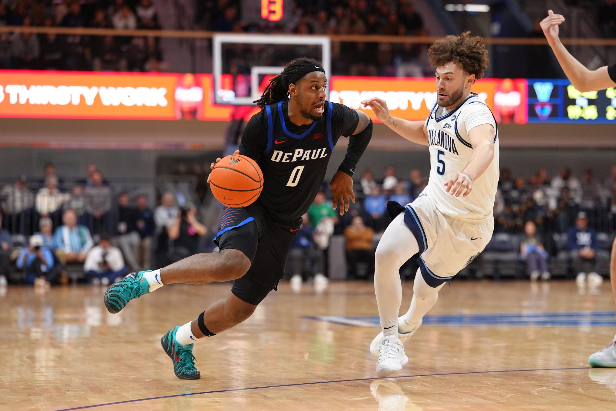 Dec 31, 2025; Villanova, Pennsylvania, USA; DePaul Blue Demons guard Brandon Maclin (0) drives against Villanova Wildcats guard Devin Askew (5) in the second half at William B. Finneran Pavilion. Mandatory Credit: Kyle Ross-Imagn Images