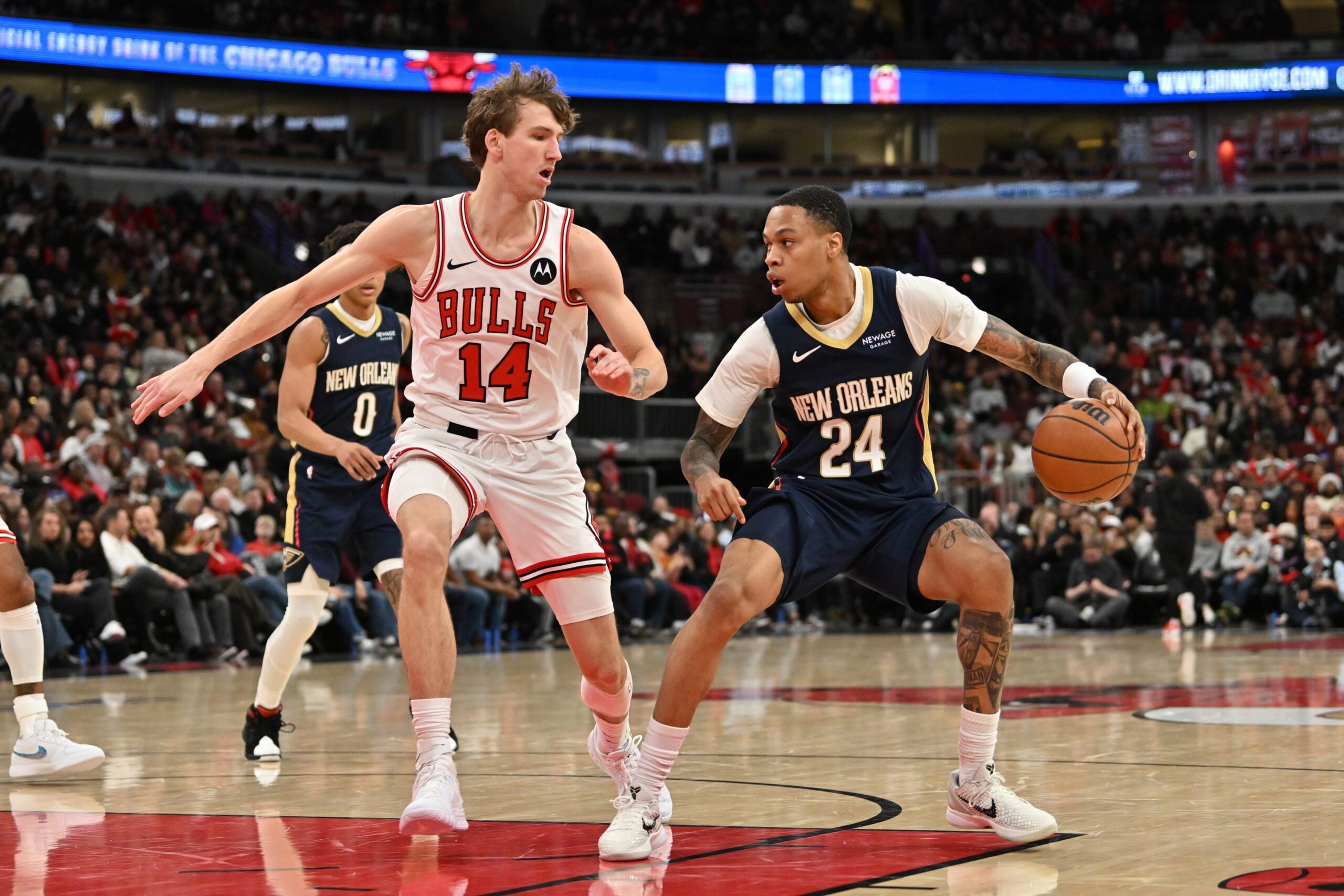 Dec 31, 2025; Chicago, Illinois, USA; New Orleans Pelicans guard Jordan Hawkins (24) controls the ball against Chicago Bulls forward Matas Buzelis (14) during the second half at United Center. Mandatory Credit: Patrick Gorski-Imagn Images