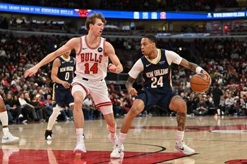 Dec 31, 2025; Chicago, Illinois, USA; New Orleans Pelicans guard Jordan Hawkins (24) controls the ball against Chicago Bulls forward Matas Buzelis (14) during the second half at United Center. Mandatory Credit: Patrick Gorski-Imagn Images