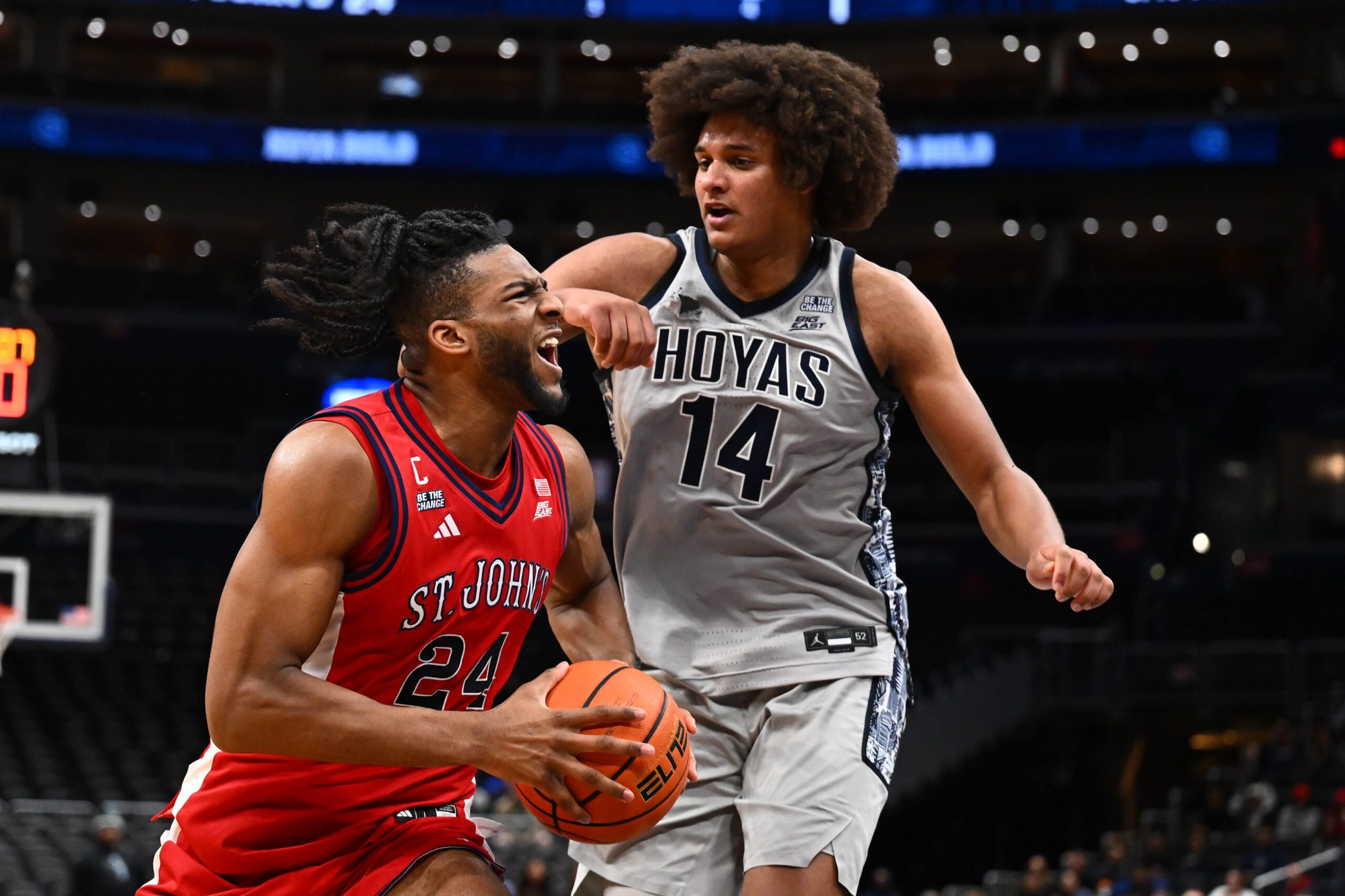 Dec 31, 2025; Washington, District of Columbia, USA; St. John's Red Storm forward Zuby Ejiofor (24) drives to the basket as Georgetown Hoyas center Seal Diouf (14) defends during the first half at Capital One Arena. Mandatory Credit: Brad Mills-Imagn Images
