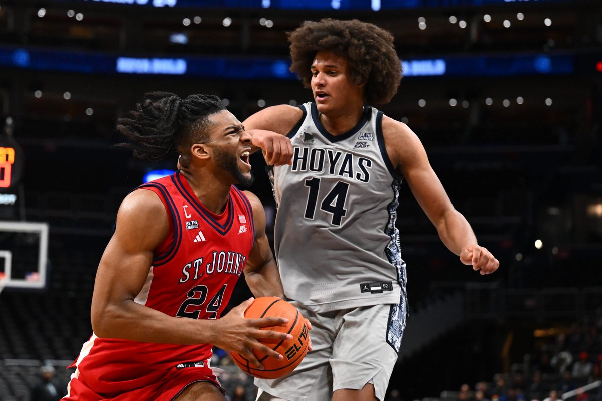 Dec 31, 2025; Washington, District of Columbia, USA; St. John's Red Storm forward Zuby Ejiofor (24) drives to the basket as Georgetown Hoyas center Seal Diouf (14) defends during the first half at Capital One Arena. Mandatory Credit: Brad Mills-Imagn Images