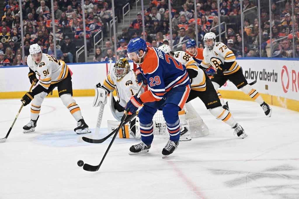 Dec 31, 2025; Edmonton, Alberta, CAN; Edmonton Oilers center Leon Draisaitl (29) plays the puck in front of Boston Bruins goalie Jeremy Swayman (1) during the third period at Rogers Place. Mandatory Credit: Walter Tychnowicz-Imagn Images