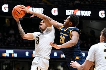 Dec 29, 2025; Nashville, Tennessee, USA; Vanderbilt Commodores guard Tyler Harris (8) lays the ball in over New Haven Chargers forward Tristian Burth (20) during the second half at Memorial Gymnasium. Mandatory Credit: Steve Roberts-Imagn Images
