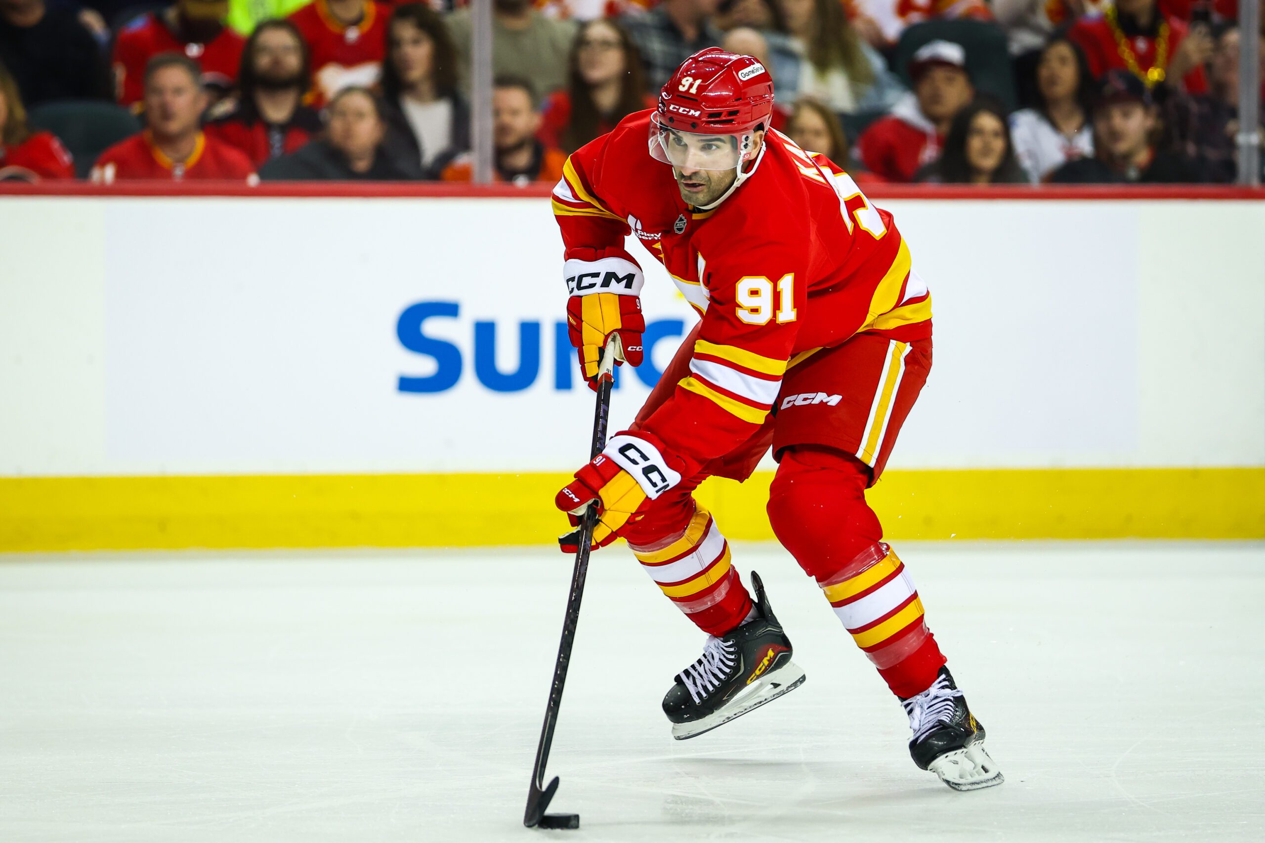 Dec 31, 2025; Calgary, Alberta, CAN; Calgary Flames center Nazem Kadri (91) controls the puck against the Philadelphia Flyers during the second period at Scotiabank Saddledome. Mandatory Credit: Sergei Belski-Imagn Images