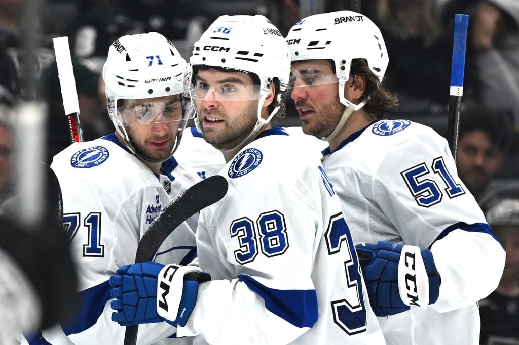 Jan 1, 2026; Los Angeles, California, USA; Tampa Bay Lightning center Anthony Cirelli (71), Tampa Bay Lightning left wing Brandon Hagel (38), and Tampa Bay Lightning defenseman Charle-Edouard D'Astous (51) celebrate a goal during the third period against the Los Angeles Kings at Crypto.com Arena. Mandatory Credit: Griffin Hooper-Imagn Images