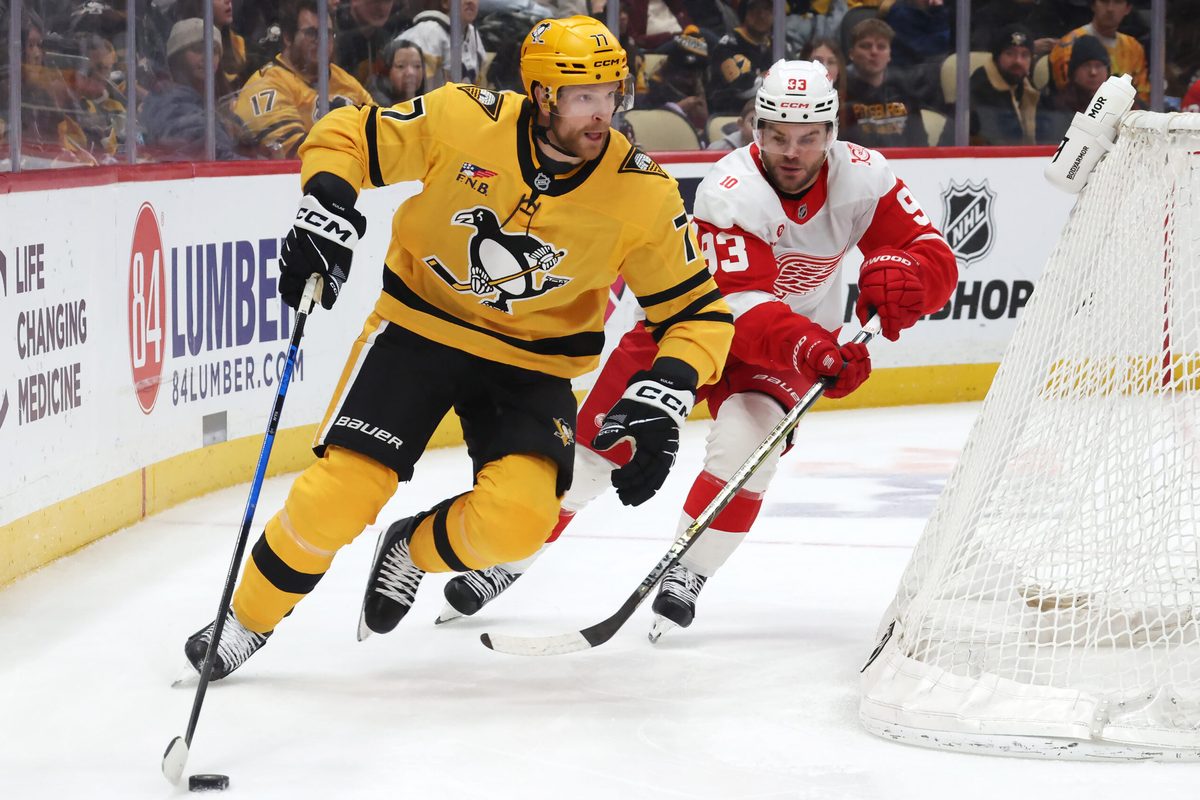 Jan 1, 2026; Pittsburgh, Pennsylvania, USA; Pittsburgh Penguins defenseman Brett Kulak (77) moves the puck as Detroit Red Wings right wing Alex Debrincat (93) chases during the third period at PPG Paints Arena. Mandatory Credit: Charles LeClaire-Imagn Images