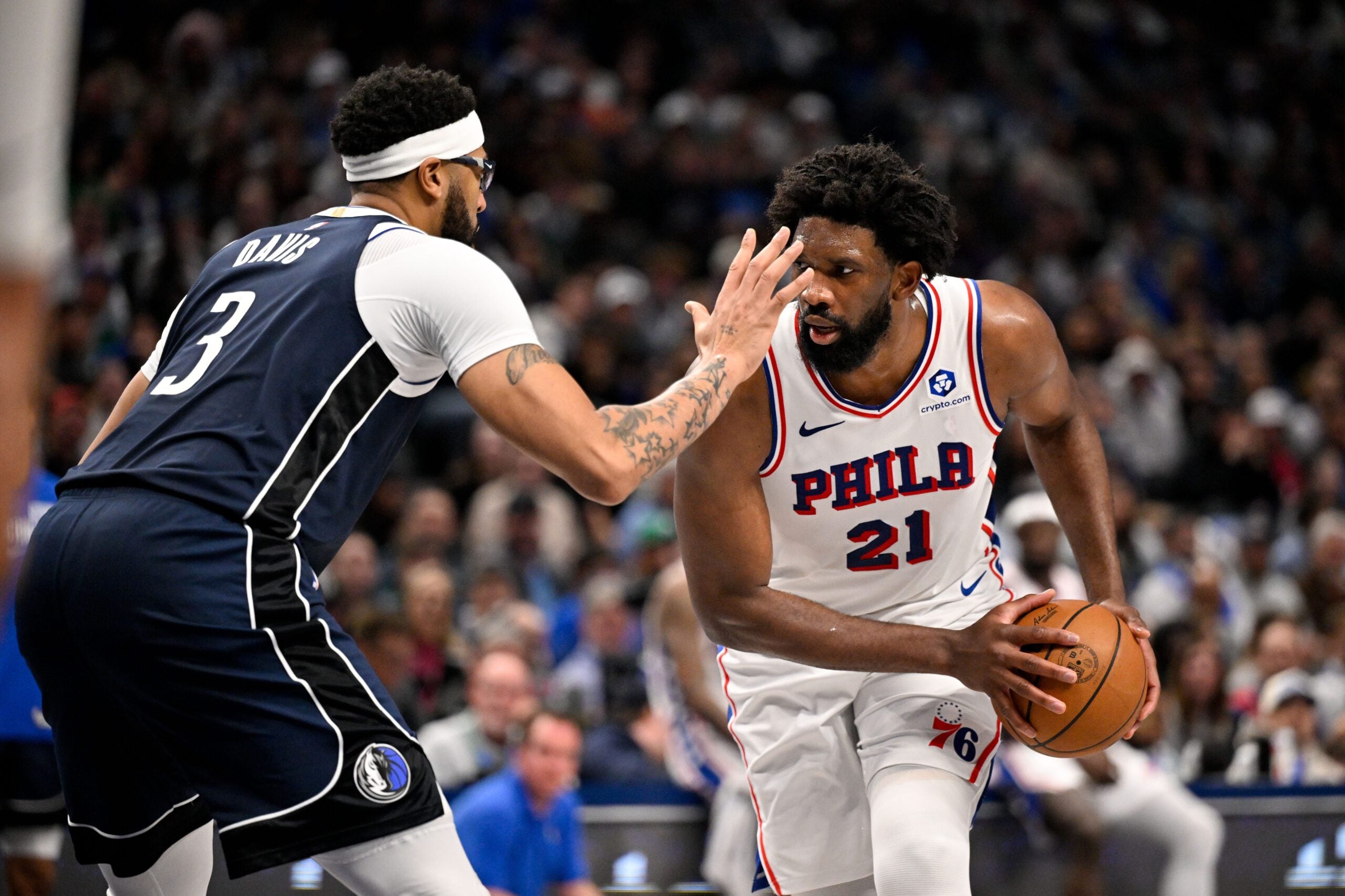 Jan 1, 2026; Dallas, Texas, USA; Philadelphia 76ers center Joel Embiid (21) looks to move the ball past Dallas Mavericks forward Anthony Davis (3) during the second half at the American Airlines Center. Mandatory Credit: Jerome Miron-Imagn Images
