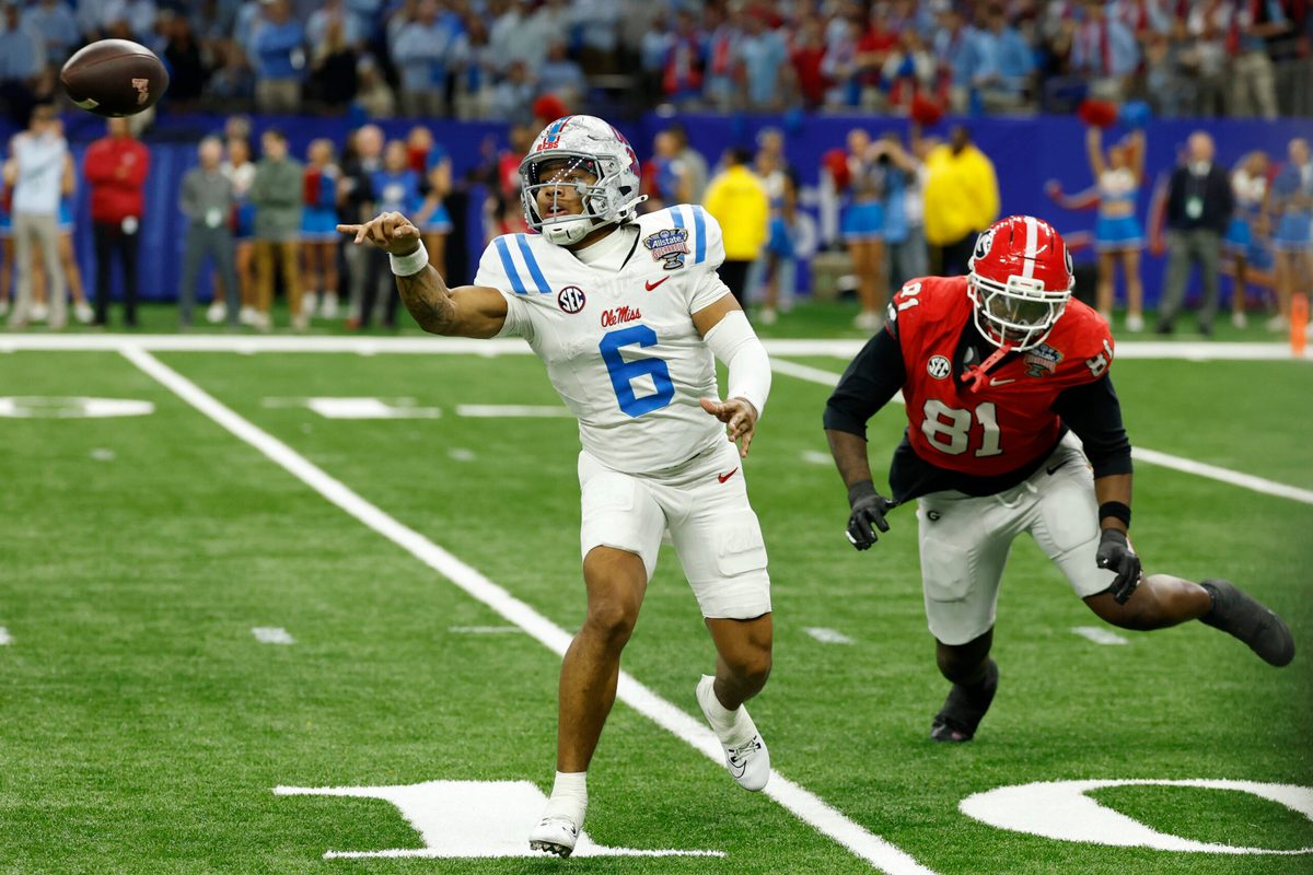 Jan 1, 2026; New Orleans, LA, USA; Mississippi Rebels quarterback Trinidad Chambliss (6) tosses the ball as Georgia Bulldogs defensive tackle Josh Horton (81) chases in the fourth quarter during the 2025 Sugar Bowl and quarterfinal game of the College Football Playoff at Caesars Superdome. Mandatory Credit: Geoff Burke-Imagn Images