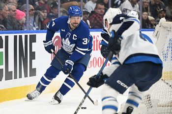 Jan 1, 2026; Toronto, Ontario, CAN;  Toronto Maple Leafs forward Auston Matthews (34) controls the puck behind the Winnipeg Jets goal in the third period at Scotiabank Arena. Mandatory Credit: Dan Hamilton-Imagn Images
