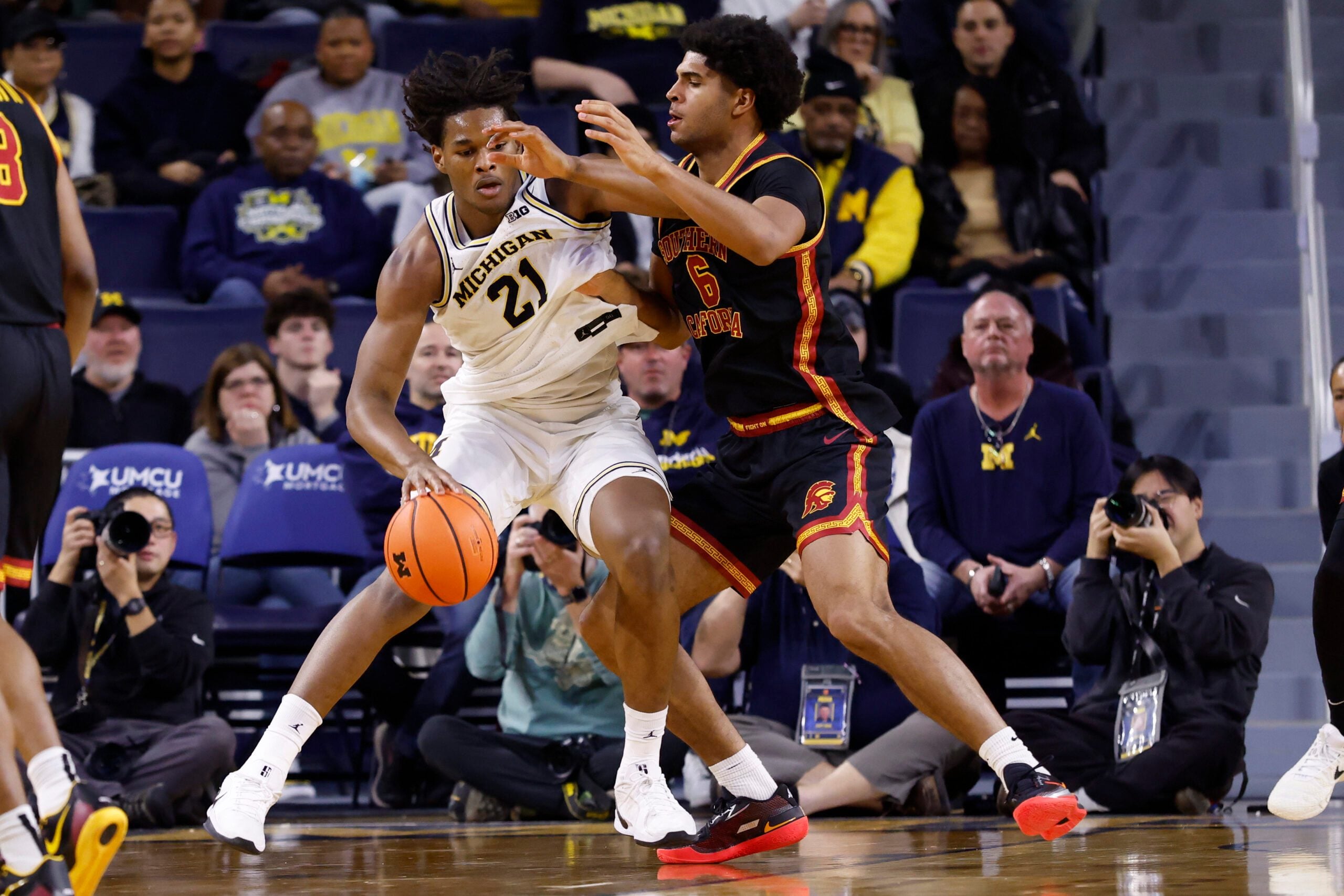 Jan 2, 2026; Ann Arbor, Michigan, USA;  Michigan Wolverines forward Morez Johnson Jr. (21) is defended by Southern California Trojans forward Jacob Cofie (6) in the second half at Crisler Center. Mandatory Credit: Rick Osentoski-Imagn Images