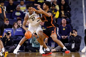 Jan 2, 2026; Ann Arbor, Michigan, USA;  Michigan Wolverines forward Morez Johnson Jr. (21) is defended by Southern California Trojans forward Jacob Cofie (6) in the second half at Crisler Center. Mandatory Credit: Rick Osentoski-Imagn Images