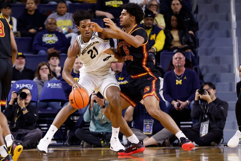 Jan 2, 2026; Ann Arbor, Michigan, USA; Michigan Wolverines forward Morez Johnson Jr. (21) is defended by Southern California Trojans forward Jacob Cofie (6) in the second half at Crisler Center. Mandatory Credit: Rick Osentoski-Imagn Images