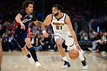Jan 2, 2026; Cleveland, Ohio, USA; Denver Nuggets guard Jamal Murray (27) drives on Cleveland Cavaliers guard Craig Porter Jr. (9) during the second half at Rocket Arena. Mandatory Credit: David Dermer-Imagn Images