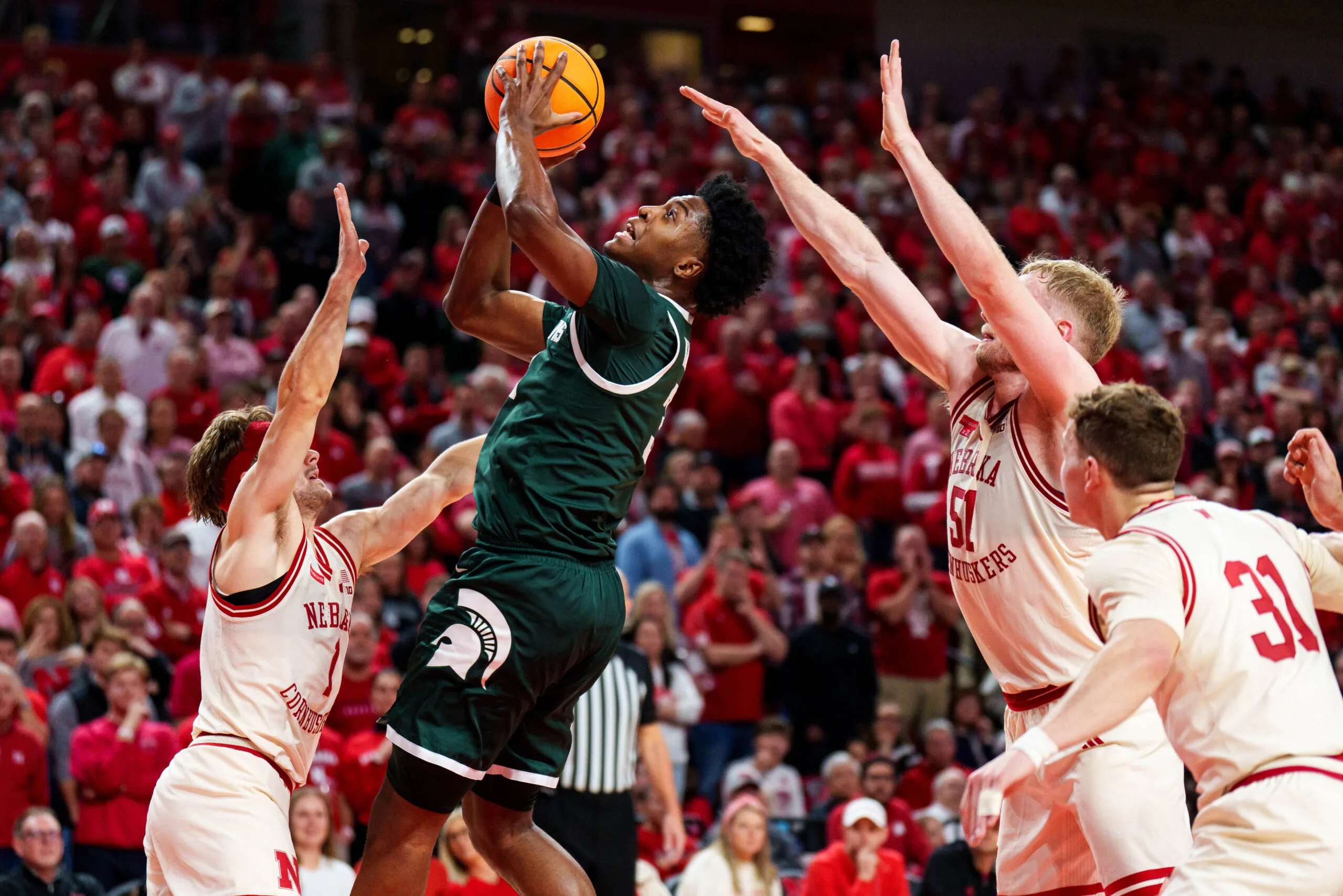 Jan 2, 2026; Lincoln, Nebraska, USA; Michigan State Spartans forward Cameron Ward (3) shoots the ball against Nebraska Cornhuskers guard Sam Hoiberg (1) and forward Rienk Mast (51) during the second half at Pinnacle Bank Arena. Mandatory Credit: Dylan Widger-Imagn Images