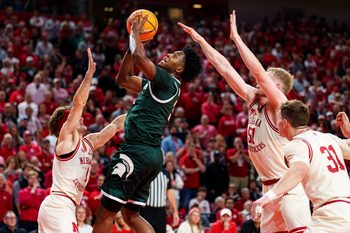 Jan 2, 2026; Lincoln, Nebraska, USA; Michigan State Spartans forward Cameron Ward (3) shoots the ball against Nebraska Cornhuskers guard Sam Hoiberg (1) and forward Rienk Mast (51) during the second half at Pinnacle Bank Arena. Mandatory Credit: Dylan Widger-Imagn Images