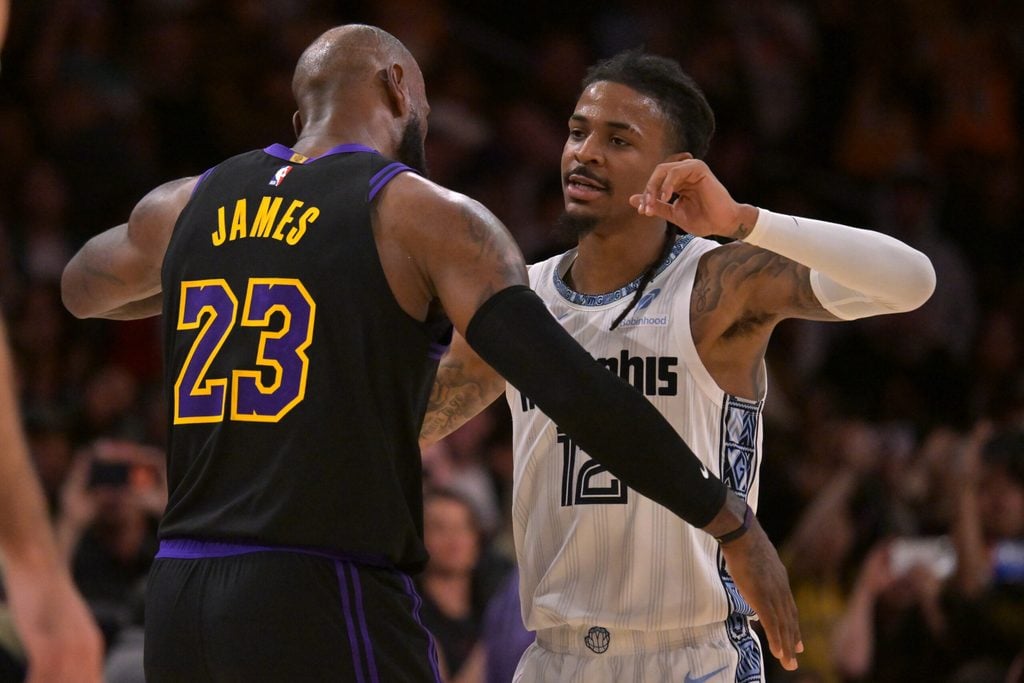 Jan 2, 2026; Los Angeles, California, USA; Los Angeles Lakers forward LeBron James (23) and Memphis Grizzlies guard Ja Morant (12) embrace following the game at Crypto.com Arena. Mandatory Credit: Jayne Kamin-Oncea-Imagn Images