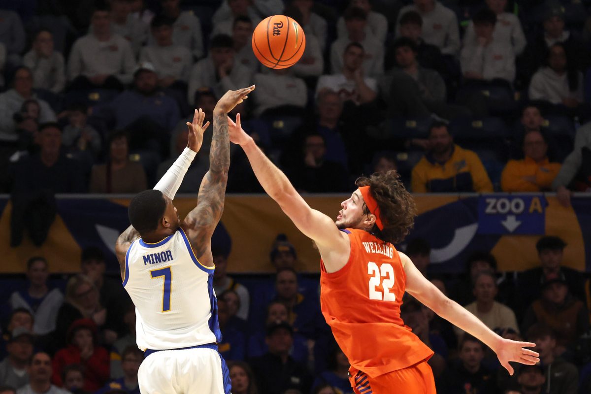 Jan 3, 2026; Pittsburgh, Pennsylvania, USA; Pittsburgh Panthers guard Damarco Minor (7) shoots a three point basket against Clemson Tigers center Carter Welling (22) during the second half at the Petersen Events Center. Mandatory Credit: Charles LeClaire-Imagn Images