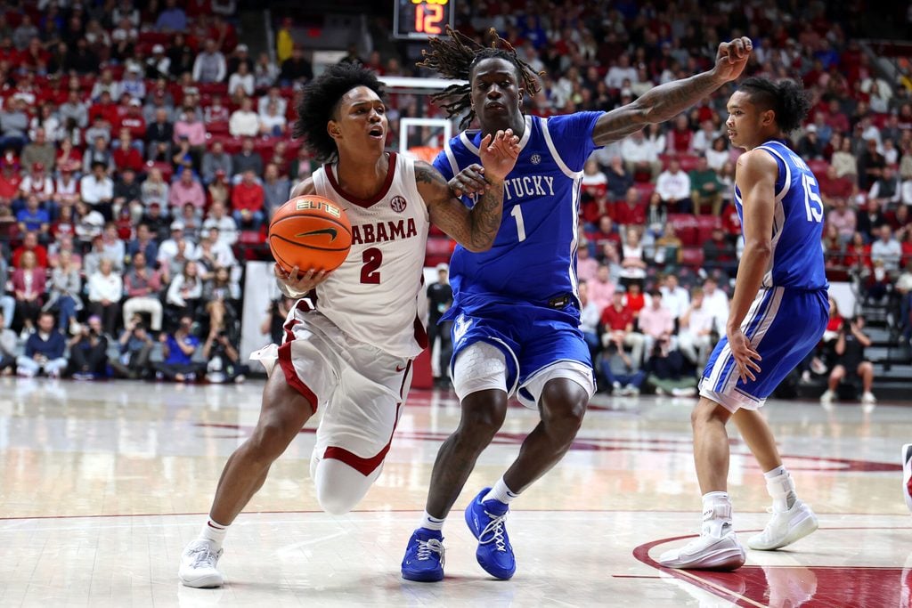 Jan 3, 2026; Tuscaloosa, Alabama, USA; Alabama Crimson Tide guard Aden Holloway (2) dribbles against Kentucky Wildcats guard Denzel Aberdeen (1) during the second half at Coleman Coliseum. Mandatory Credit: David Leong-Imagn Images