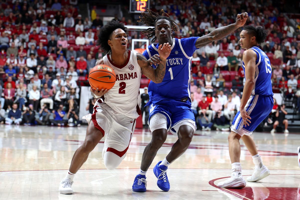 Jan 3, 2026; Tuscaloosa, Alabama, USA; Alabama Crimson Tide guard Aden Holloway (2) dribbles against Kentucky Wildcats guard Denzel Aberdeen (1) during the second half at Coleman Coliseum. Mandatory Credit: David Leong-Imagn Images