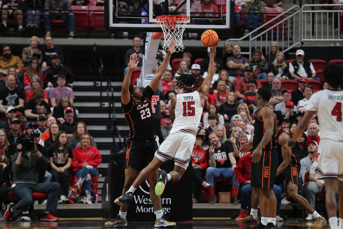 Jan 3, 2026; Lubbock, Texas, USA; Texas Tech Red Raiders forward JT Toppin (15) takes a shot against Oklahoma State Cowboys center Benjamin Ahmed (23) in the second half at United Supermarkets Arena. Mandatory Credit: Michael C. Johnson-Imagn Images