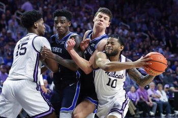 Jan 3, 2026; Manhattan, Kansas, USA; Kansas State Wildcats guard David Castillo (10) goes to the basket against Brigham Young Cougars forwards Mihailo Boskovic (5) and Kennard Davis Jr. (30) during the second half at Bramlage Coliseum. Mandatory Credit: Scott Sewell-Imagn Images