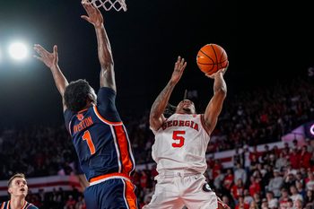 Jan 3, 2026; Athens, Georgia, USA; Georgia Bulldogs guard Jeremiah Wilkinson (5) tries to shoot against Auburn Tigers guard Kevin Overton (1) during the first half at Stegeman Coliseum. Mandatory Credit: Dale Zanine-Imagn Images