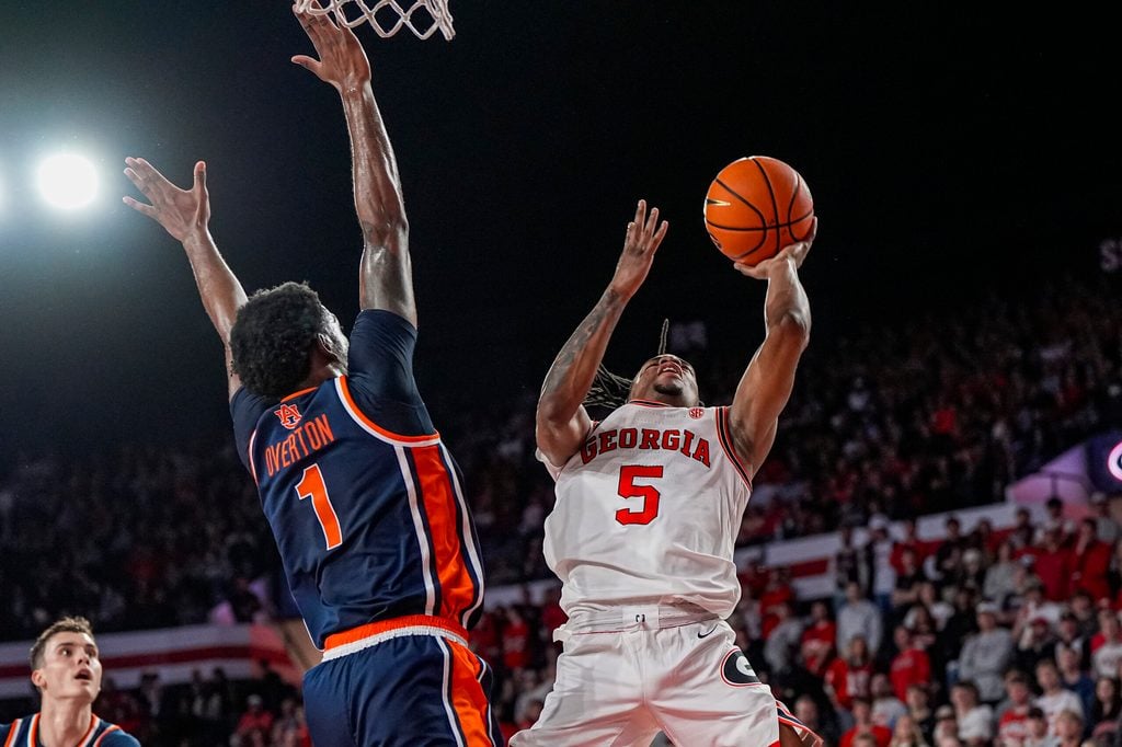 Jan 3, 2026; Athens, Georgia, USA; Georgia Bulldogs guard Jeremiah Wilkinson (5) tries to shoot against Auburn Tigers guard Kevin Overton (1) during the first half at Stegeman Coliseum. Mandatory Credit: Dale Zanine-Imagn Images