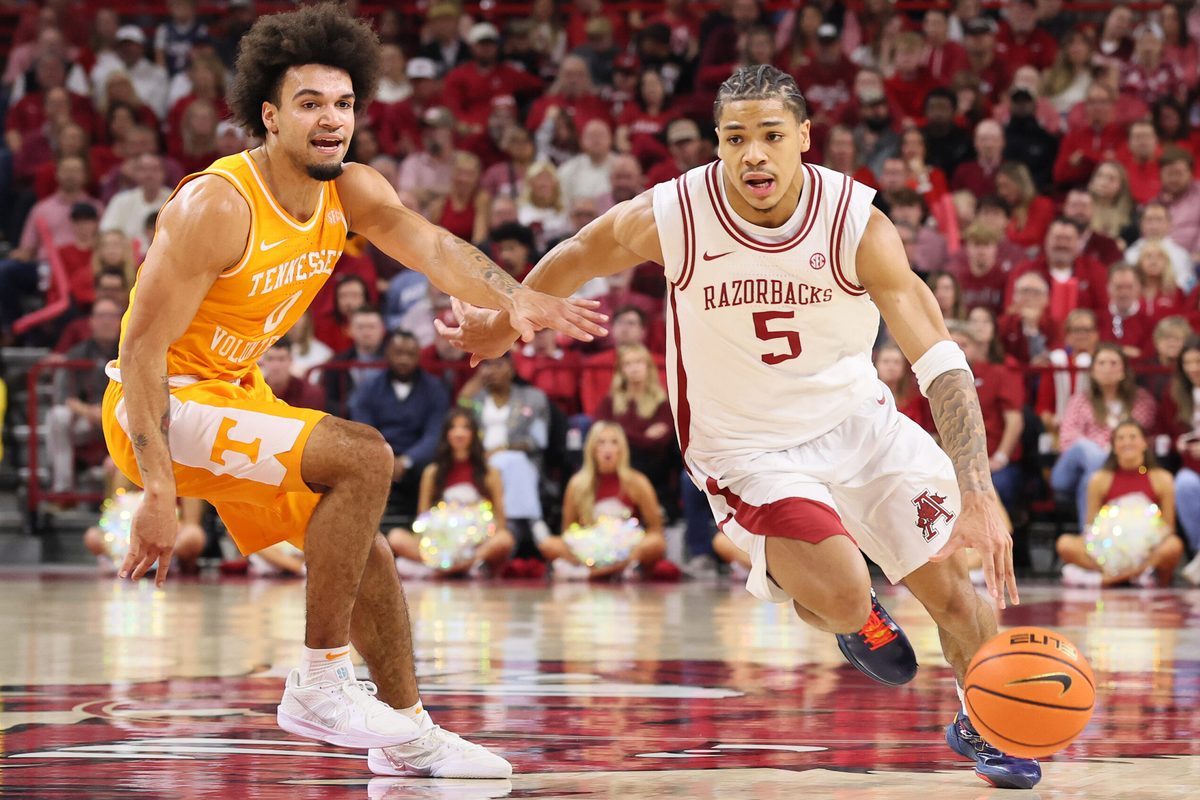 Jan 3, 2026; Fayetteville, Arkansas, USA; Arkansas Razorbacks guard Darius Acuff Jr (5) drives against Tennessee Volunteers guard Jacobi Gillespie (0) during the second half at Bud Walton Arena. Mandatory Credit: Nelson Chenault-Imagn Images