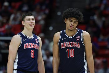 Jan 3, 2026; Salt Lake City, Utah, USA; Arizona Wildcats forward Ivan Kharchenkov (8) and forward Koa Peat (10) wait for play to resume after a time in the the second half of the game against the Utah Utes at Jon M. Huntsman Center. Mandatory Credit: Rob Gray-Imagn Images