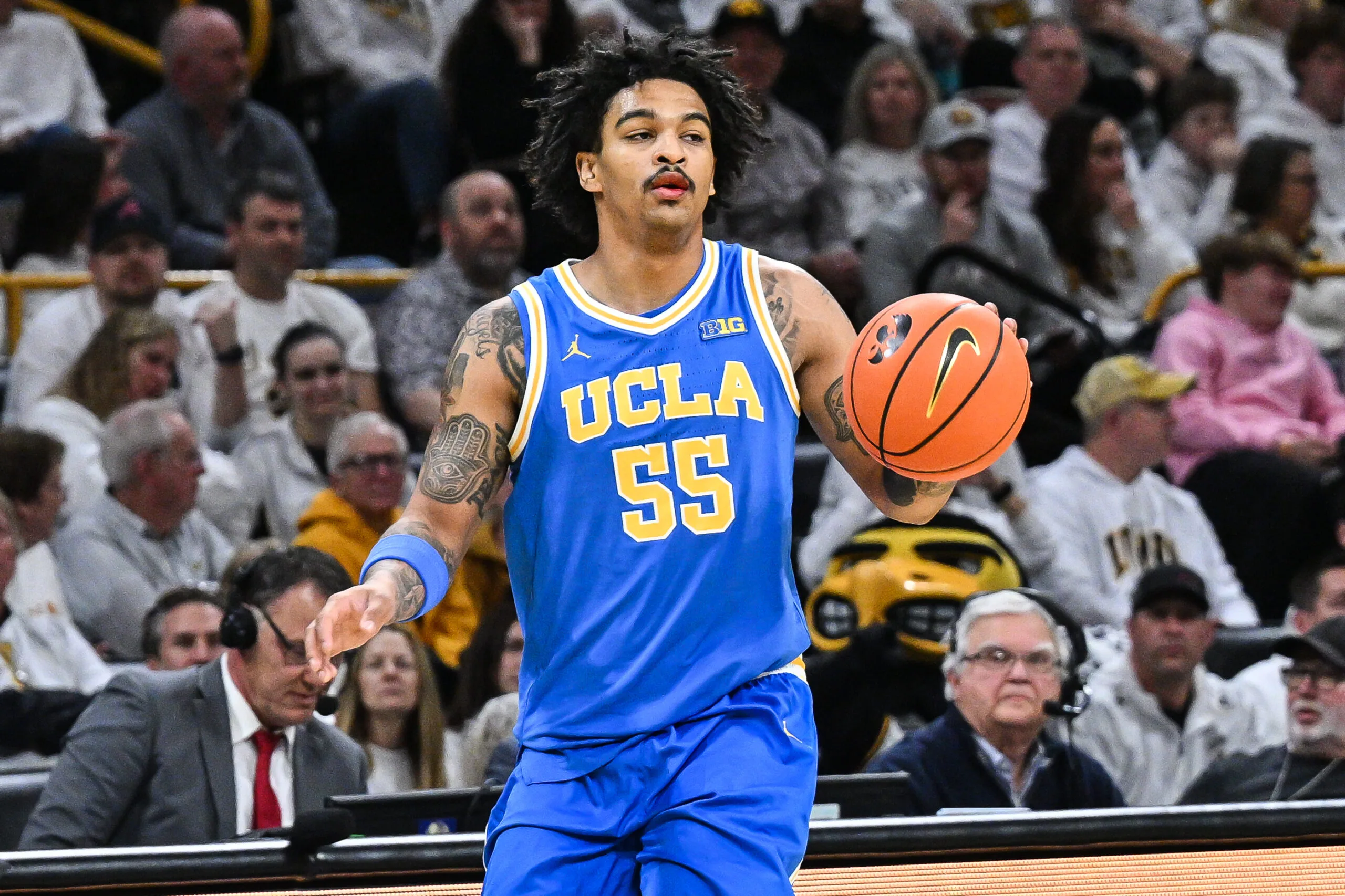Jan 3, 2026; Iowa City, Iowa, USA; UCLA Bruins guard Skyy Clark (55) controls the ball against the Iowa Hawkeyes during the first half at Carver-Hawkeye Arena. Mandatory Credit: Jeffrey Becker-Imagn Images