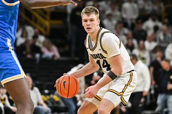 Jan 3, 2026; Iowa City, Iowa, USA; Iowa Hawkeyes guard Bennett Stirtz (14) controls the ball against the UCLA Bruins during the second half at Carver-Hawkeye Arena. Mandatory Credit: Jeffrey Becker-Imagn Images