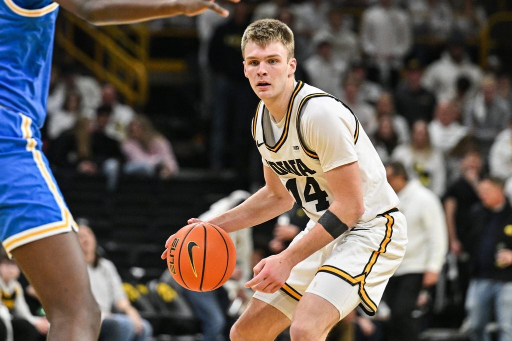 Jan 3, 2026; Iowa City, Iowa, USA; Iowa Hawkeyes guard Bennett Stirtz (14) controls the ball against the UCLA Bruins during the second half at Carver-Hawkeye Arena. Mandatory Credit: Jeffrey Becker-Imagn Images