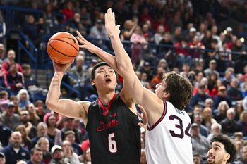 Jan 2, 2026; Spokane, Washington, USA; Seattle U Redhawks center Houran Dan (6) shoots the ball against Gonzaga Bulldogs forward Braden Huff (34) in the second half at McCarthey Athletic Center. Mandatory Credit: James Snook-Imagn Images