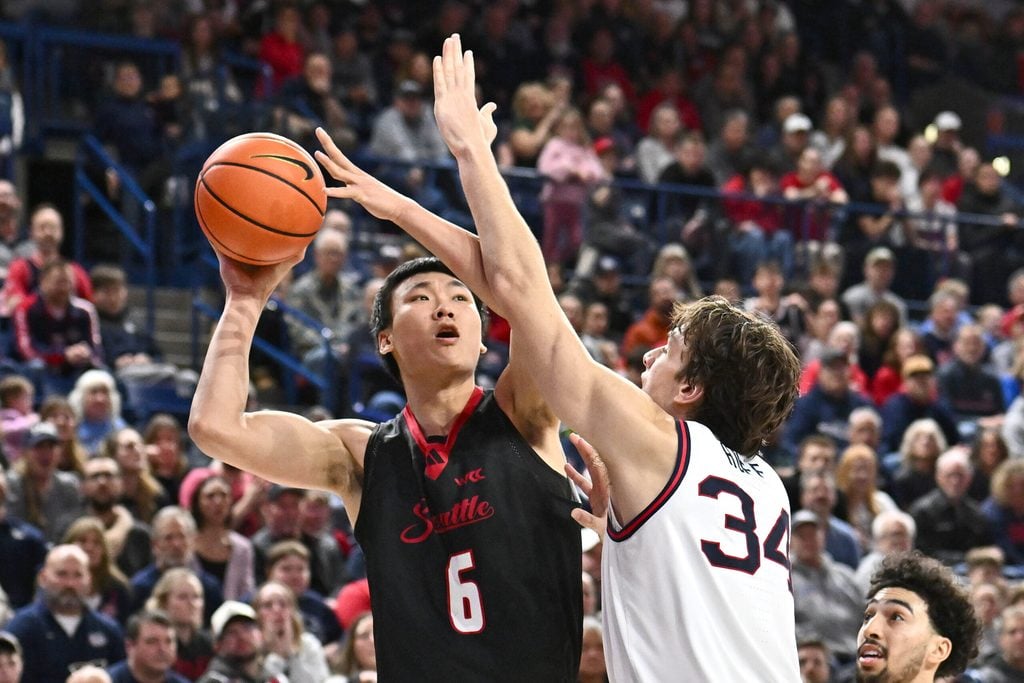 Jan 2, 2026; Spokane, Washington, USA; Seattle U Redhawks center Houran Dan (6) shoots the ball against Gonzaga Bulldogs forward Braden Huff (34) in the second half at McCarthey Athletic Center. Mandatory Credit: James Snook-Imagn Images