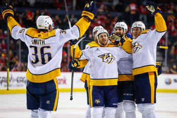 Jan 3, 2026; Calgary, Alberta, CAN; Nashville Predators defenseman Nicolas Hague (41) celebrates his goal with teammates against the Calgary Flames during the third period at Scotiabank Saddledome. Mandatory Credit: Sergei Belski-Imagn Images