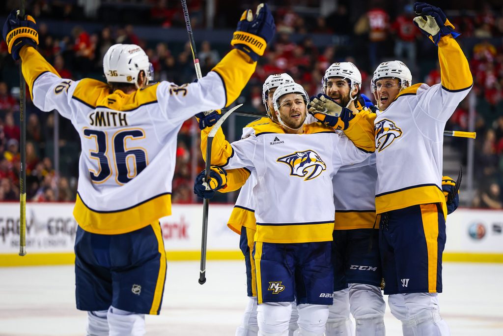 Jan 3, 2026; Calgary, Alberta, CAN; Nashville Predators defenseman Nicolas Hague (41) celebrates his goal with teammates against the Calgary Flames during the third period at Scotiabank Saddledome. Mandatory Credit: Sergei Belski-Imagn Images