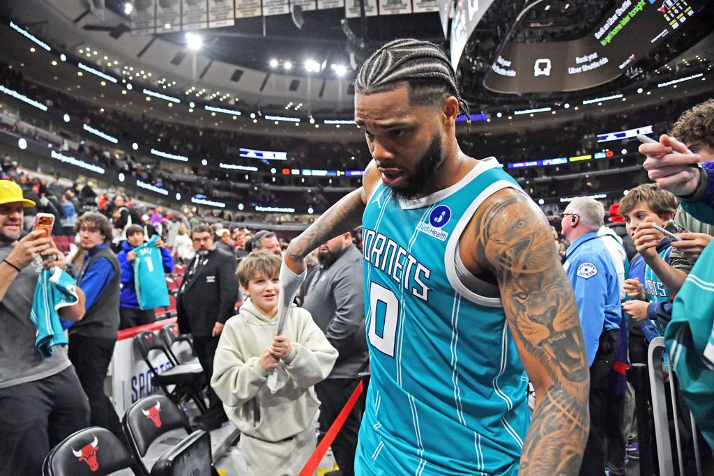 Jan 3, 2026; Chicago, Illinois, USA; Charlotte Hornets forward Miles Bridges (0) gives his arm sleeve to a young fan after a game against the Chicago Bulls at United Center. Mandatory Credit: Patrick Gorski-Imagn Images