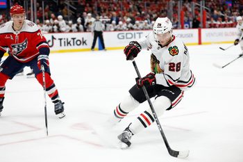 Jan 3, 2026; Washington, District of Columbia, USA; Chicago Blackhawks left wing Andre Burakovsky (28) skates with the puck as Washington Capitals defenseman John Carlson (74) defends during the third period at Capital One Arena. Mandatory Credit: Geoff Burke-Imagn Images