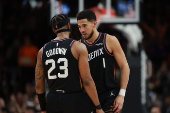 Jan 4, 2026; Phoenix, Arizona, USA; Phoenix Suns guard Devin Booker (1) celebrates with teammate Jordan Goodwin (23) against the Oklahoma City Thunder in the second half at Mortgage Matchup Center. Mandatory Credit: Mark J. Rebilas-Imagn Images