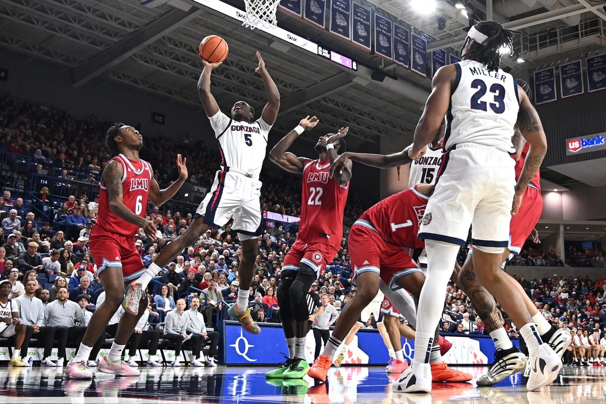 Jan 4, 2026; Spokane, Washington, USA; Gonzaga Bulldogs forward Emmanuel Innocenti (5) shoots the ball against Loyola Marymount Lions center Rick Issanza (22) in the second half at McCarthey Athletic Center. Mandatory Credit: James Snook-Imagn Images